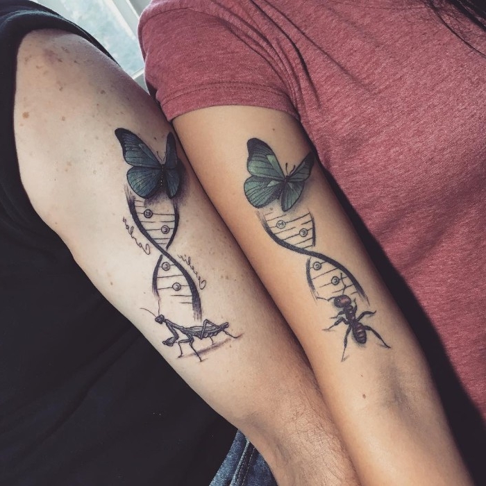 butterflies and dna strads, tattooed on the upper parts of two arms, placed next to each other, one features and ant, and the other a praying mantis, and two words