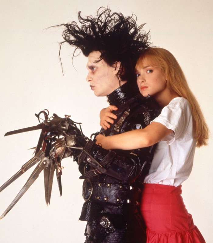 80s costumes men, johnny depp in the film edward scissorhands, black leather costume, with metal elements, and messy black wig, winnona ryder with long ginger hair