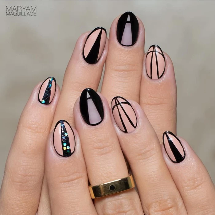 optical illusion short stiletto nails, in peach and nude, with black details, creating the illusion of sharpness, geometric nail designs, with riangles and glitter
