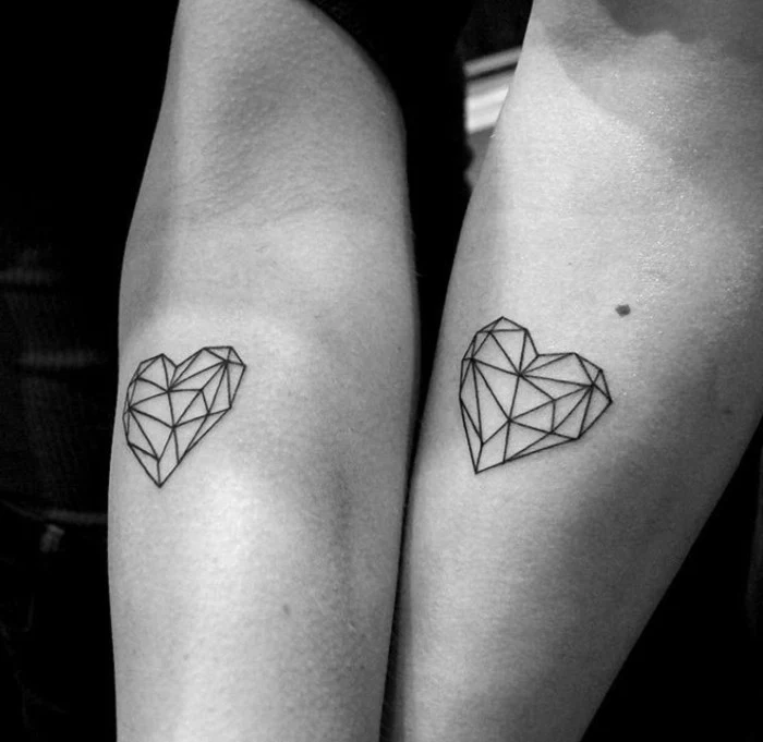 lineart geometric heart-shapes, done in black ink, near the elbow of two arms, matching couple tattoos