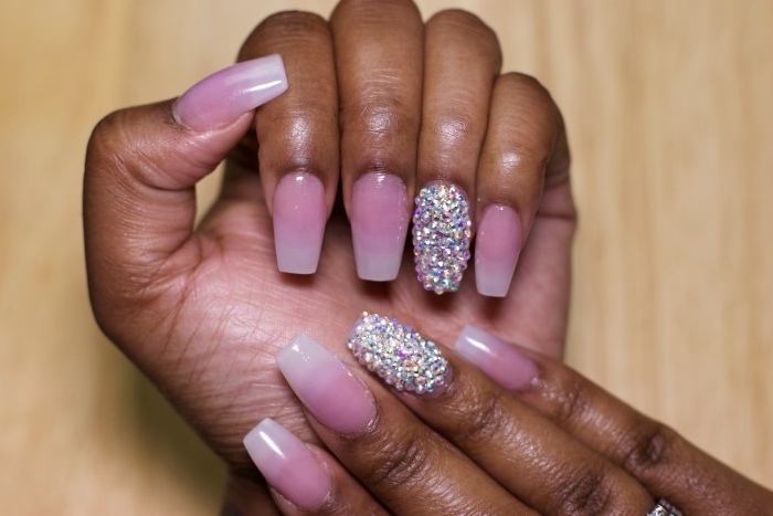 ombre-effect french manicure, on long ballerina shaped nails, nude pink nail polish, and gem decal stickers, on the ring finger nails, of both hands