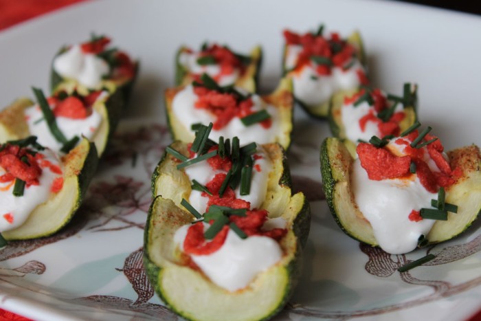 zucchini grilled and stuffed with cream cheese, garnished with chopped chives, and salsa sauce