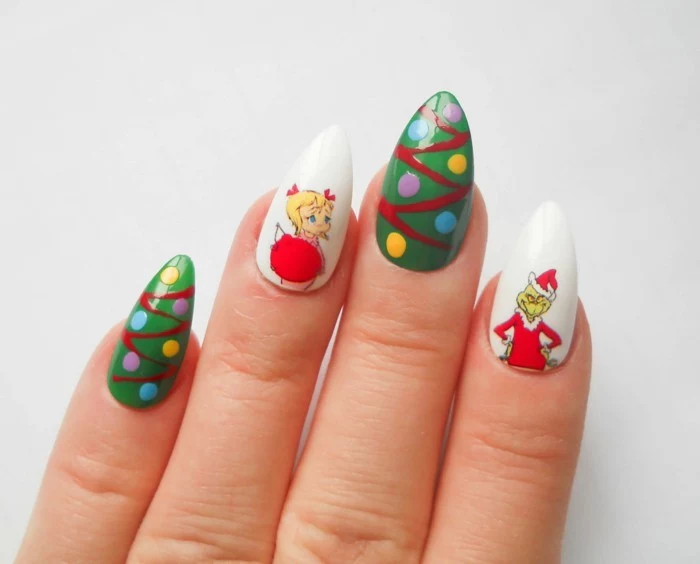 christmas-themed acrylic nail shapes, in white and green, decorated with grinch stickers, and multicolored dots