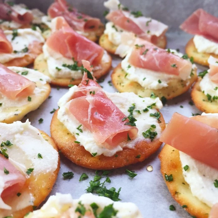 homemade crackers, topped with ricotta cheese, ham and chopped green herbs, hors d oeuvres recipes, to try at home