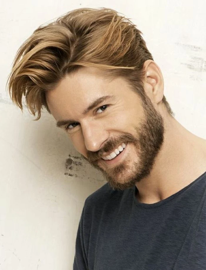 laughing bearded man, with light brunette side parted hair, and bangs brushed to one side, in a messy quiff, trendy haircuts for men