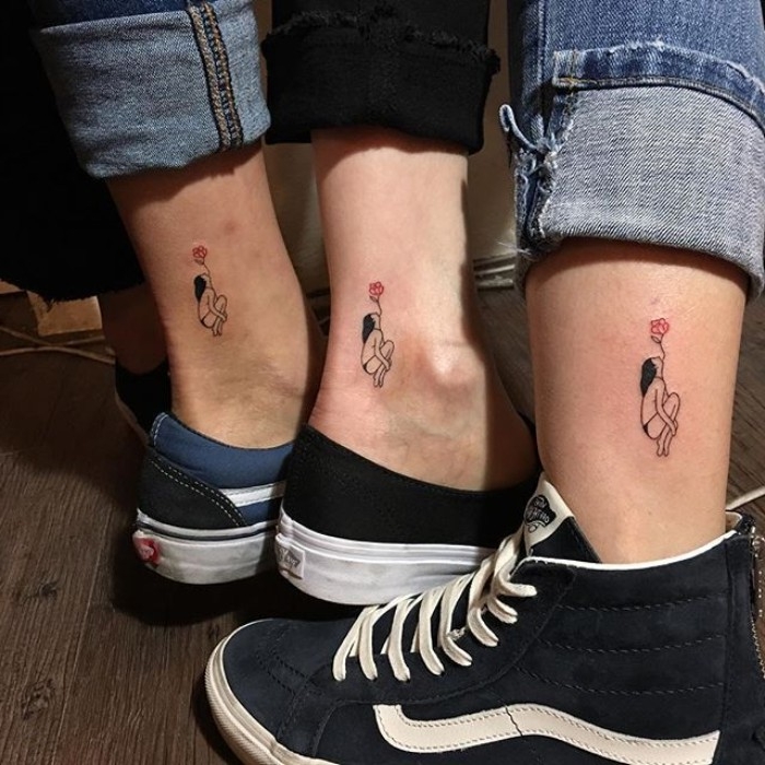 ankle tattoos featuring a girl, and a red rose, worn by three friends, in sneakers and jeans