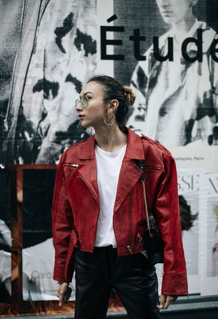 red leather jacket, inspired by michael jackson, worn over a white top, and black leather trousers, 80s outfits, on a young woman