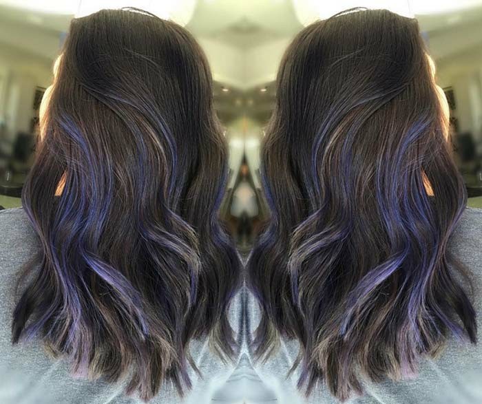 blue strands of hair, decorating a wavy, medium length dark brunette hairdo, balayage brown hair, seen in two imrrored images
