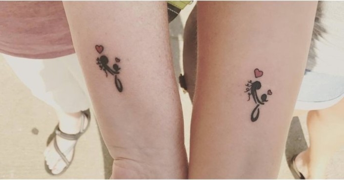 daughter and mother tattoo, featuring a stick figure with long hair, hugging a smaller stick figure, and two small red hearts