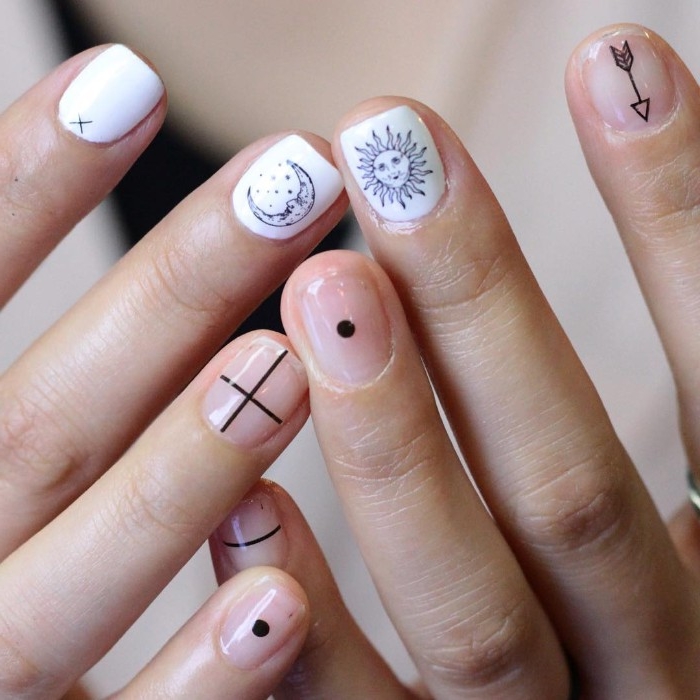 stickers depicting, sun and moon, arrow and crossing lines, dot and stripe, on short nude, and white nails