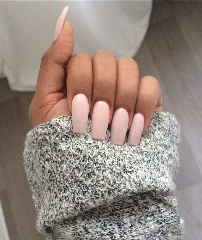 light candy pink, nude gel nails, with long ballerina slipper shape, on a hand, holding a slat and pepper knitted sleeve