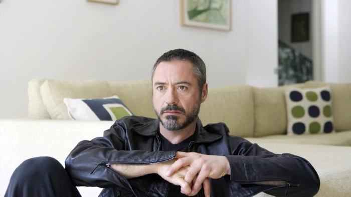contemporary photo of robert downey jr, dressed in black, and wearing a very short, buzzed haircut with grey areas