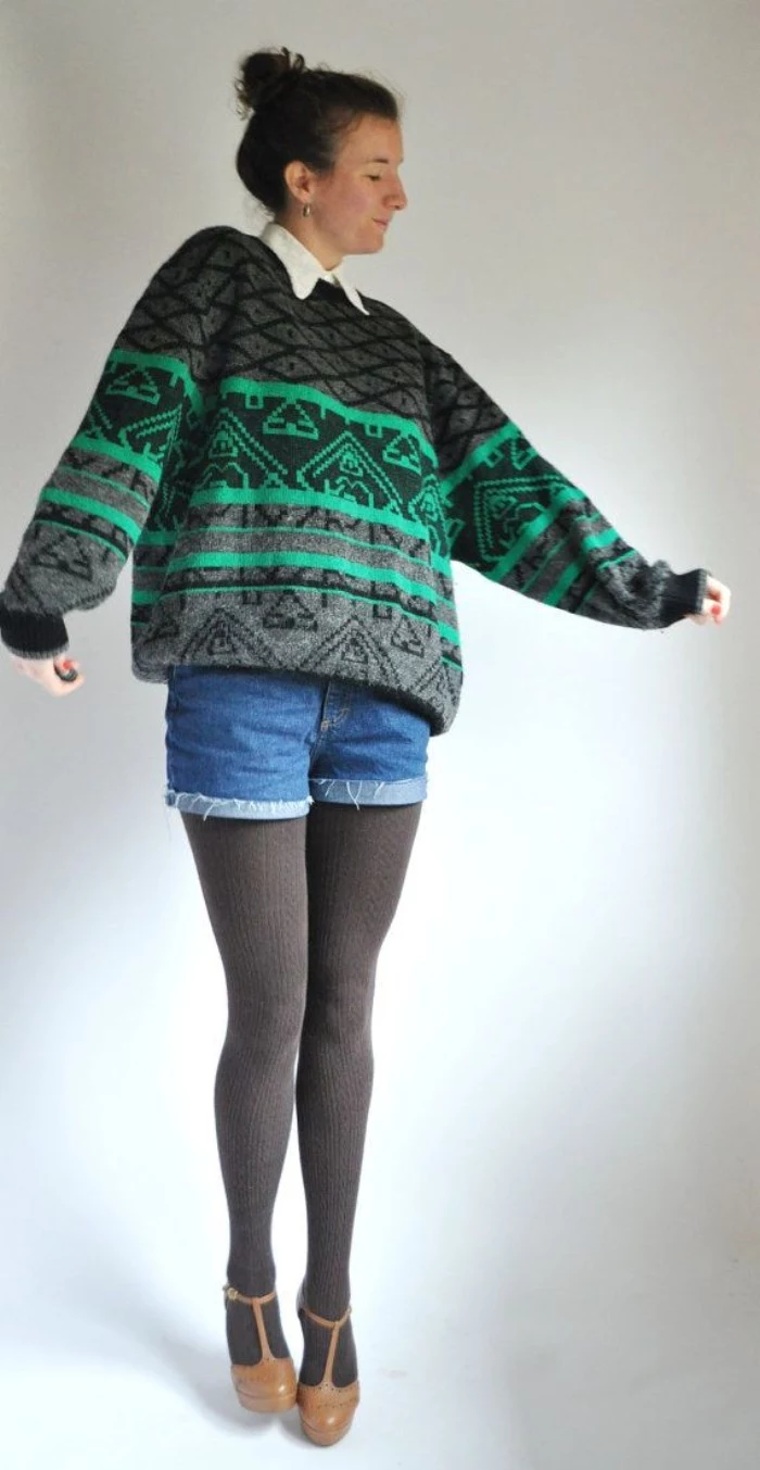 patterned sweater in grey and green, worn over a white shirt, with grey thights and denim shorts, by a young woman, with brown t-bar shoes