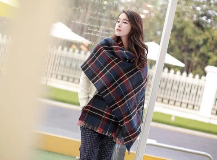 navy blue plaid oversized shawl, with black and dark red, white and grey patterns, wrapped around a pale, east asian woman, how to wrap a blanket scarf, in an original way