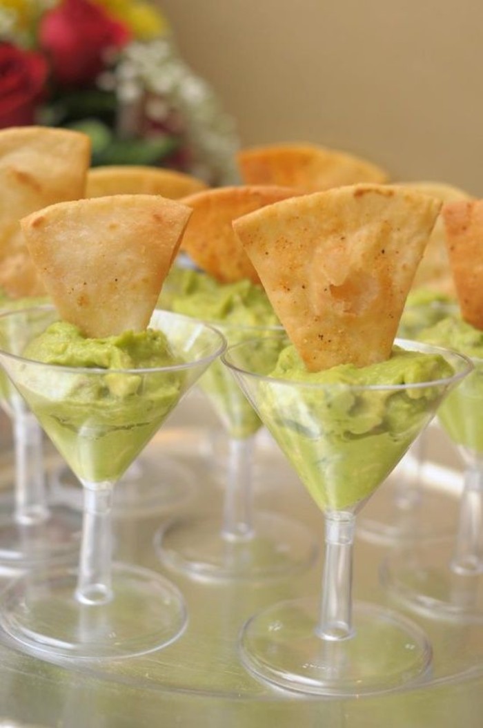 riangular slices of toasted pitta bread, dipped in plastic cocktail glasses, filled with guacamole, hor dorves