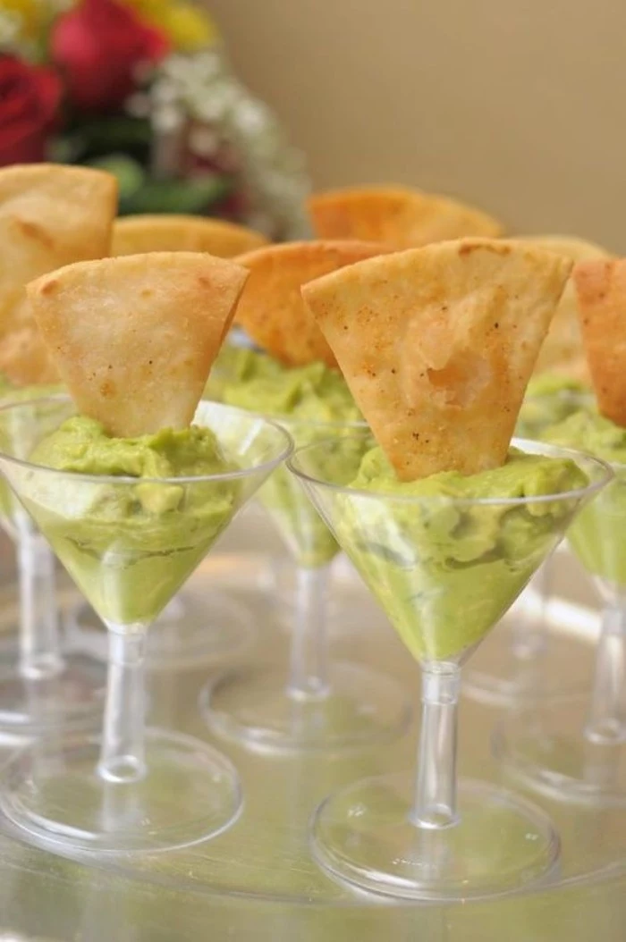 riangular slices of toasted pitta bread, dipped in plastic cocktail glasses, filled with guacamole, hor dorves