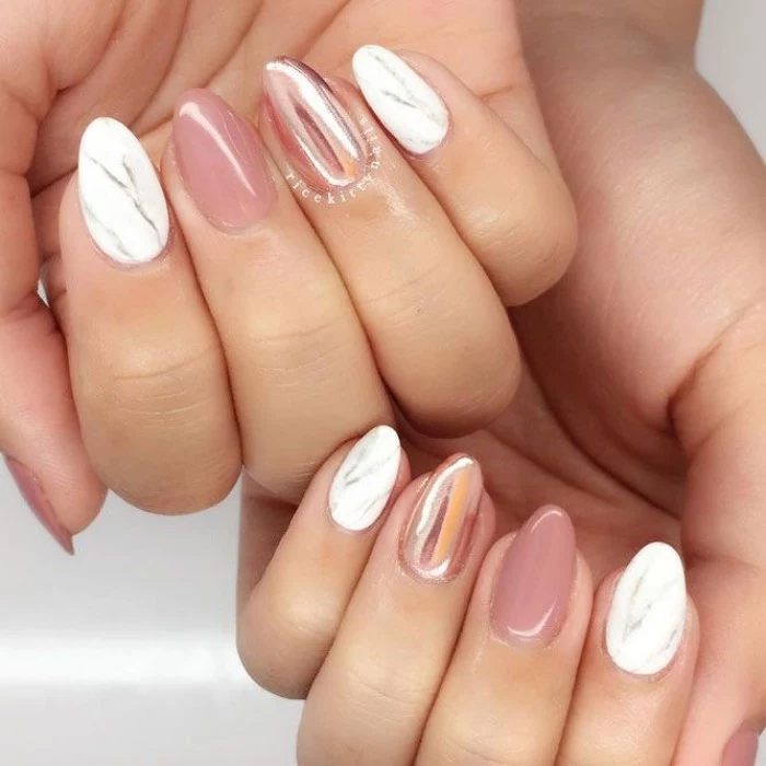 marble-like effect in white and grey, on the forefinger and little finger nails of two hands, the rest of the short pointy nails, are painted in metallic rose gold, and glossy pink
