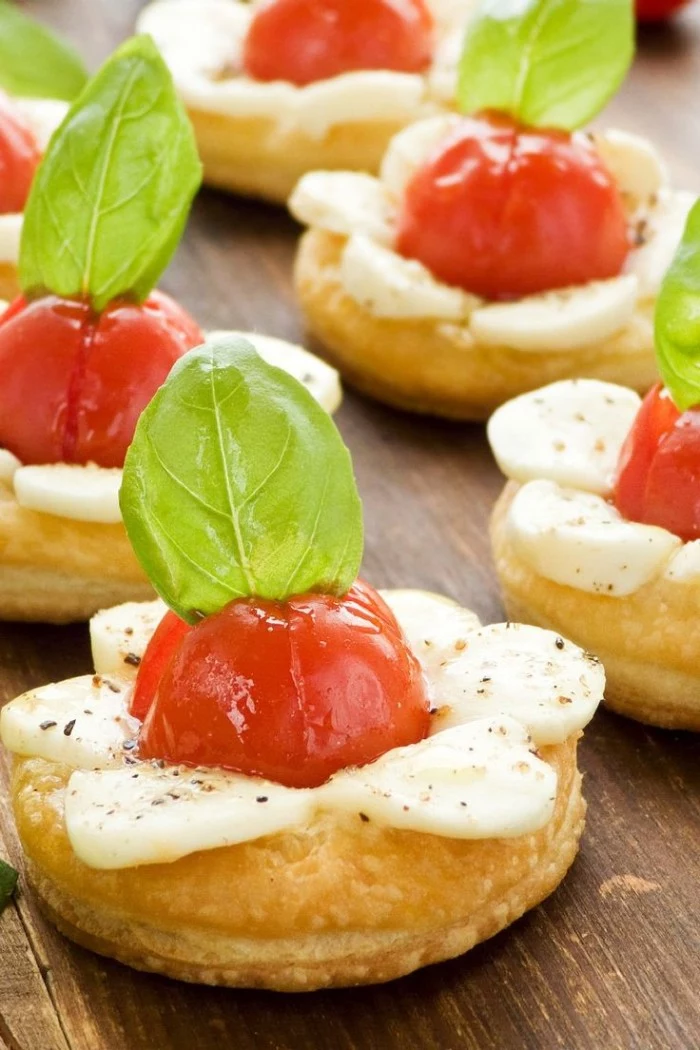 pastries topped with baked cherry tomatoes, mozzarella and fresh basil leaves, appetizers for a crowd, easy and delicious