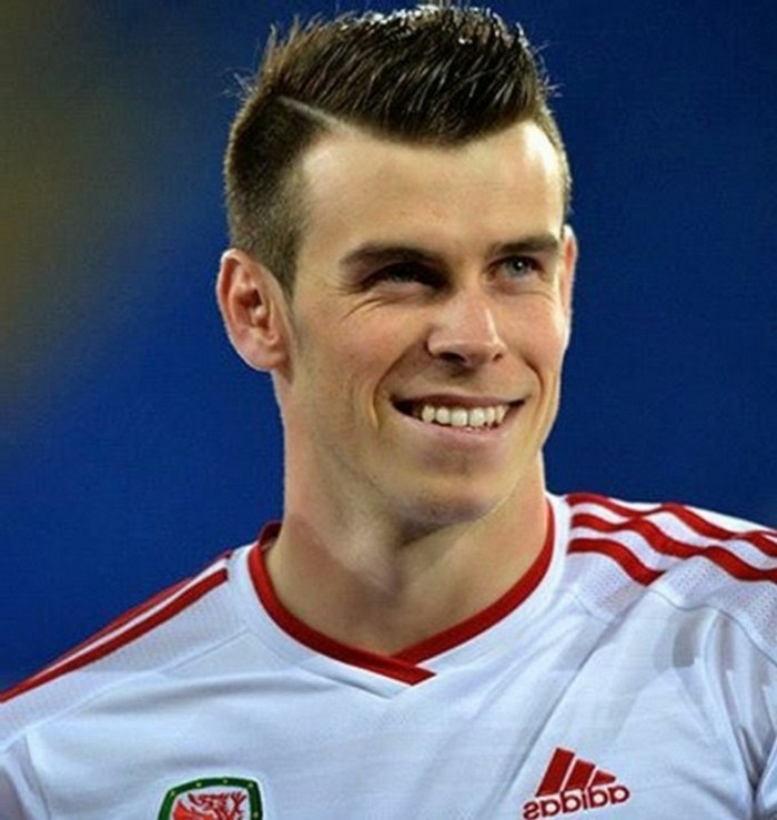 crew cut hairstyle, worn by a smiling man, in a white and red footballer's jersey, short haircuts for men, popular today