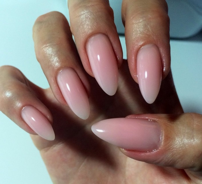 nude nail polish, smooth and glossy, milky pink nails, with a pointed, long and oval shape