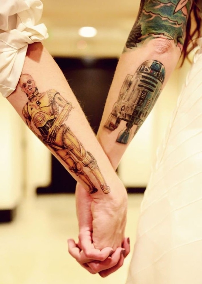 r2d2 and c3po, done in full color, on the lower part of two linked arms, matching tattoos for couples in love, and star wars fans