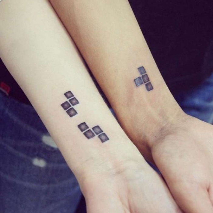 matching tattoos for couples in love, retro tetris blocks tattoos, near the wrists of two arms, each arm has a different piece, but they fit together