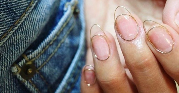 artificial manicure, short pointy nails, created with wire, stuck to a person's finger tips, seen in close up