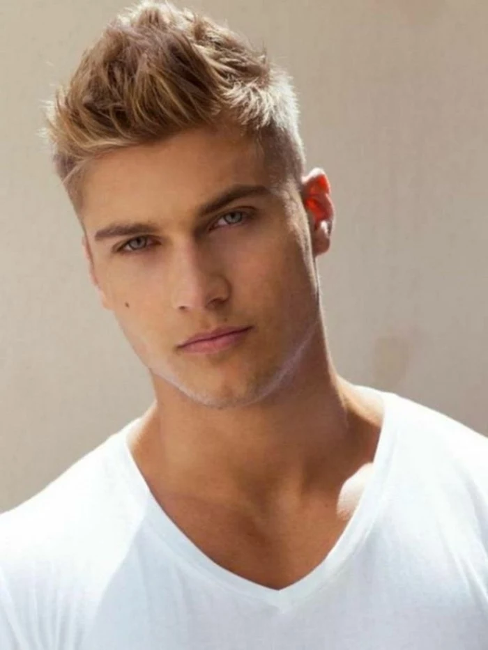 white v-neck t-shirt, worn by a young blonde man, with hair styled in a faux hawk, types of haircuts for men