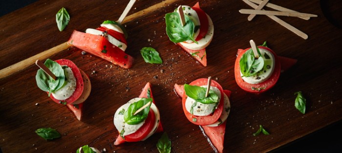 mozzarella and tomato, skewered with pieces of watermelon, and basil leaves, hor d oeuvres for the summer