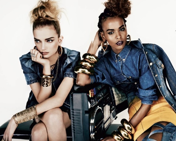 two young women, sitting next to each other, dressed in denim outfits, heavily inspired by the 1980s