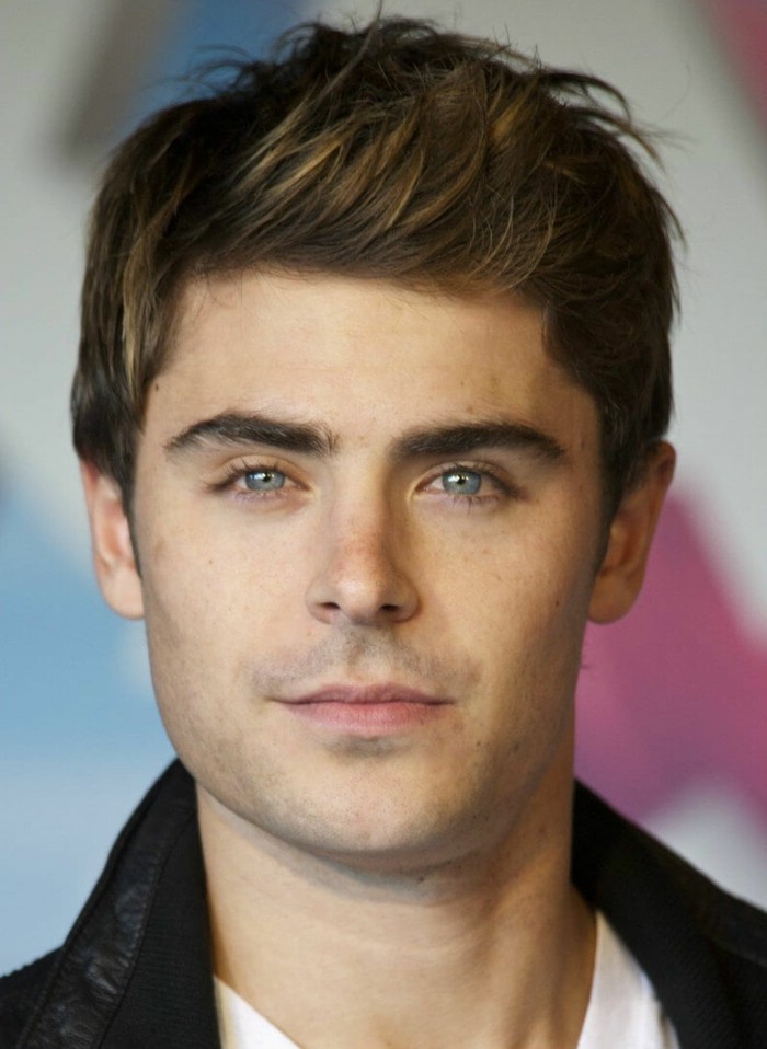 side swept quiff, on brunette hair, with subtle highlights, worn by zac efron, in a black leather jacket