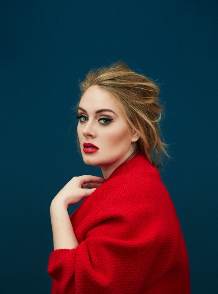 cardigan in red, worn by the singer adele, messy dark blonde hair, with light blonde highlights, black eyeliner and red lipstick