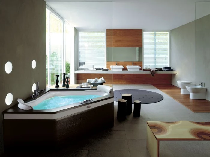 corner elevather bathtub, surrounded by dark brown wooden panels, and filled with water, inside a large and modern bathroom