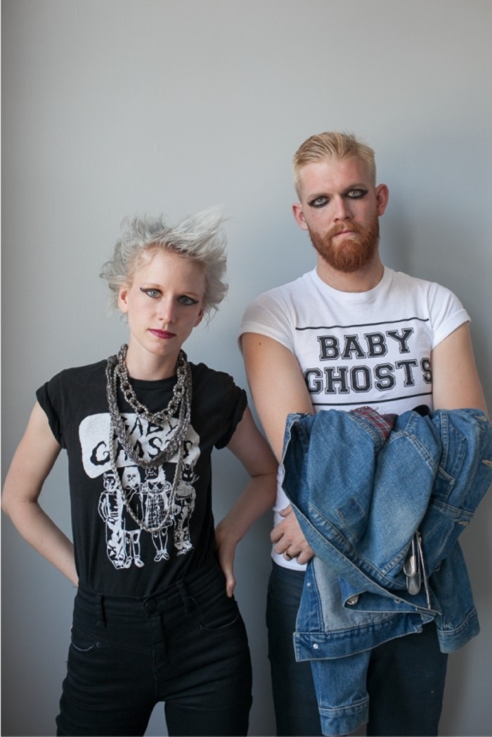 platinum blonde young woman, with spiky and messy hair, dressed in black and wearing bold eye makeup, next to a man with similar makeup, couples halloween costume ideas, punk rockers