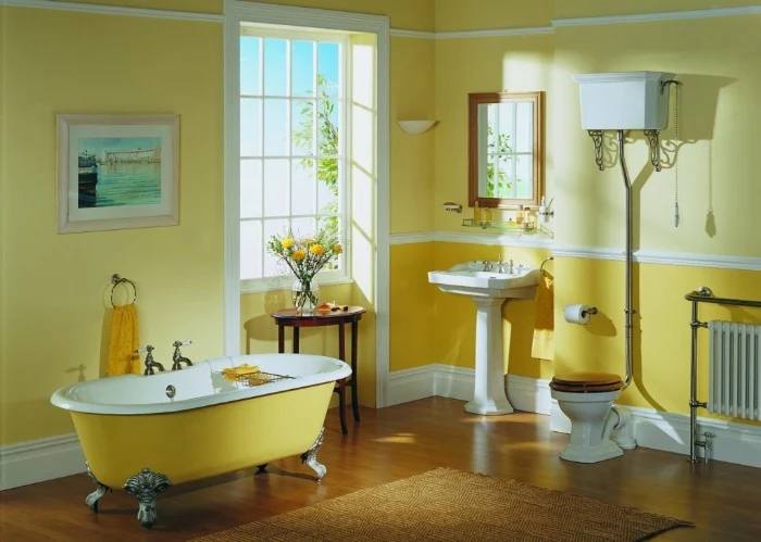 vintage style bathroom, in two shades of yellow, featuring a clafoot bathtub, a toilet and a sink, best paint for bathrooms