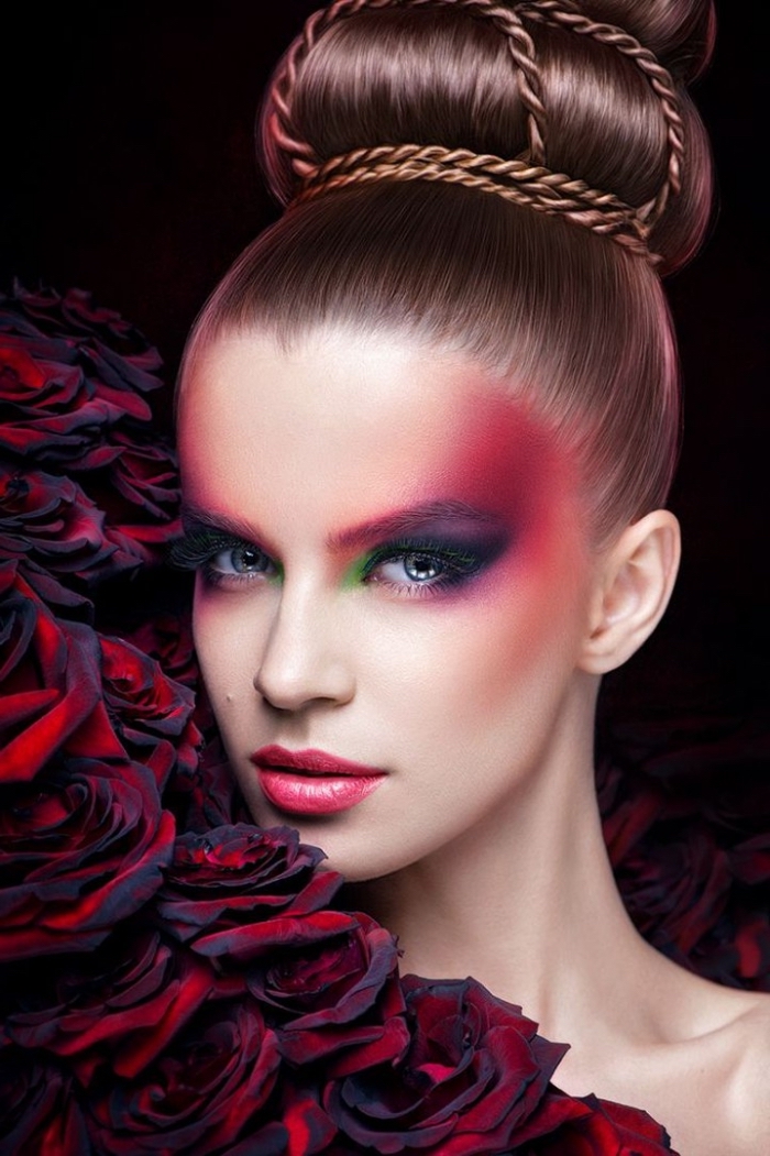 avant-garde christmas eyeshadow, in pink and violet, red and green, worn by a pale young woman, with pink lipstick, and a large ballerina bun