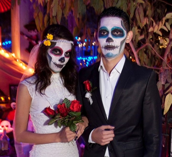 dia de los muertos halloween costumes, bride and groom with painted faces, made to look like skulls