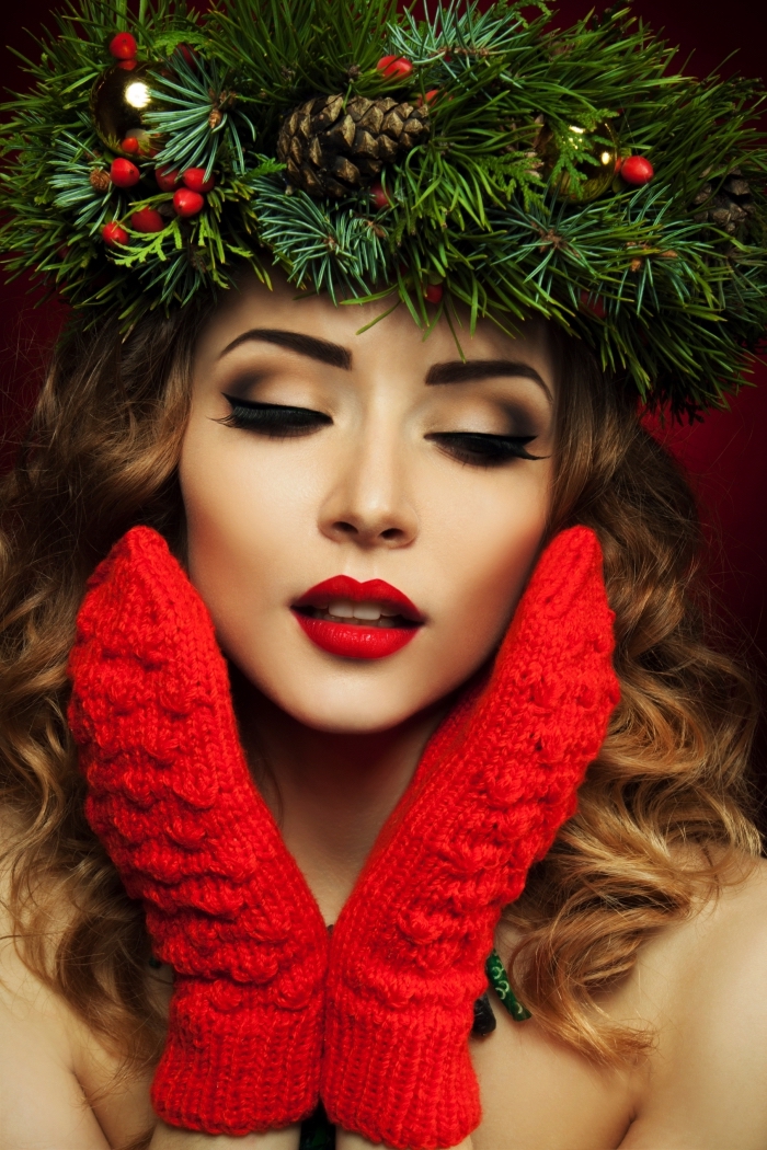 mittens in red, worn by a pale brunette woman, with curled hair, christmas makeup looks, red lipstick and smokey eye makeup, christmas werath on her head