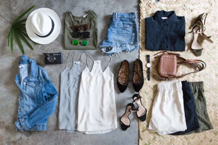 summer wardrobe essentials, two tank tops, three pairs of shorts, blue denim cutoffs, t-shirt and blouse, hat and other accessories