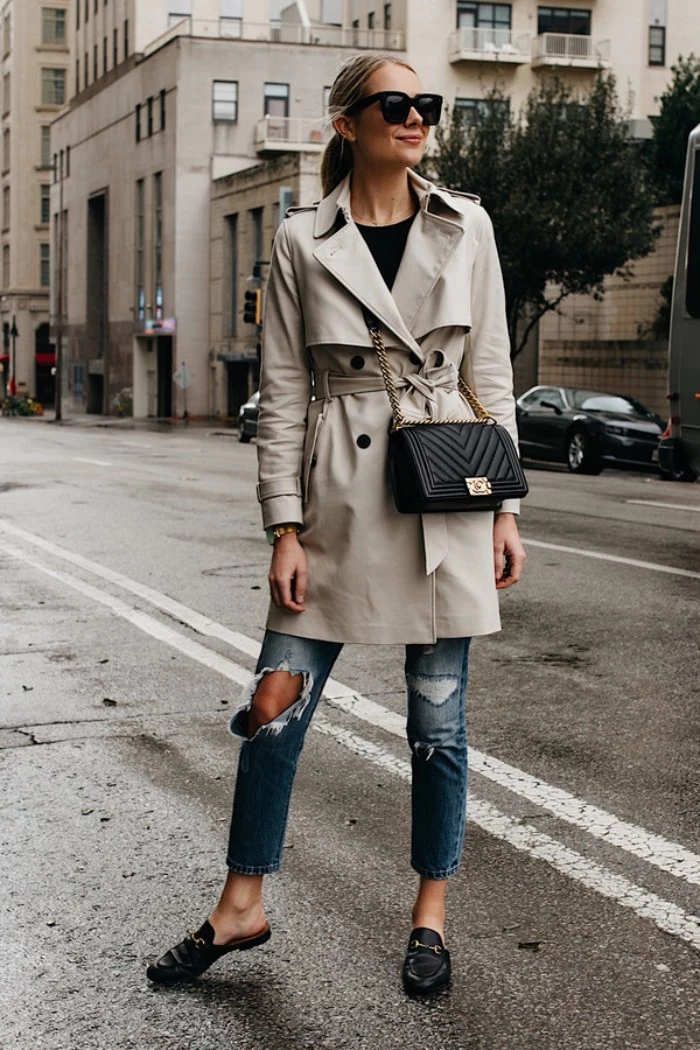 off-white trench coat, worn by a blonde woman, in ripped blue jeans, and a black top, capsule closet
