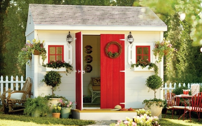 red and white shed, inside a garden, with potted plants and shrubs, shed ideas, tiled roof in light grey