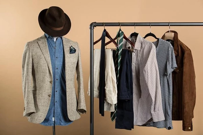 blazer in pale beige, on a dummy wearing a denim shirt, and a dark brown hat, wardrobe essentials for men, metal rack with more clothes nearby