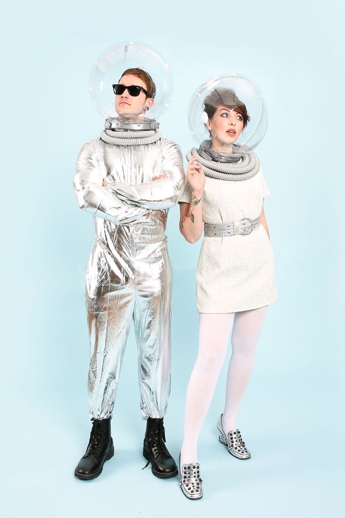 brunette young woman, and man with short brown hair, and dark sunglasses, dressed like retro astronauts, couples halloween costumes
