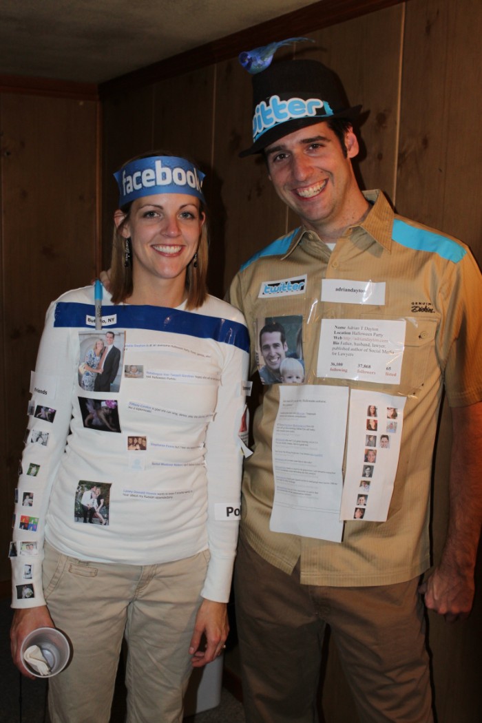 twitter and facebook costumes, made from paper print outs, stuck to the clothes of a smiling man and woman, quick halloween costumes