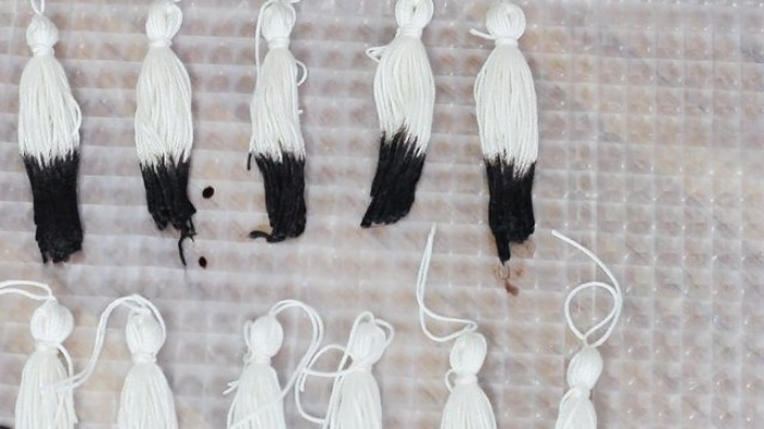 partially dyed handmade tassels, white with black tips, left to dry, bedroom makeover, with a tassel chandelier