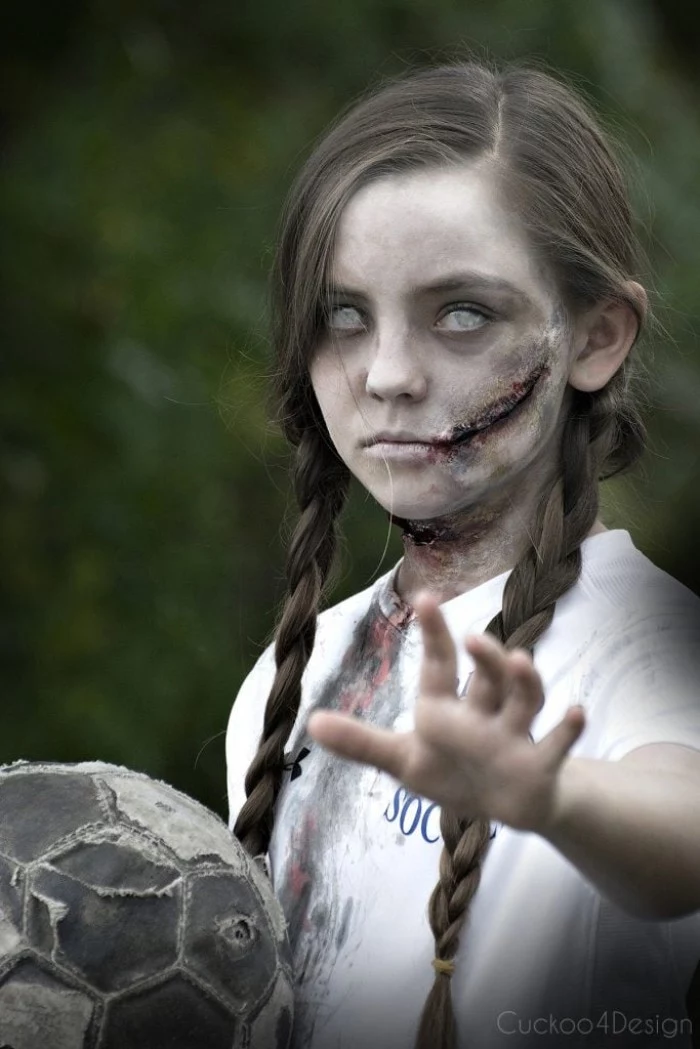 contact lenses in white, worn by a small girl, in a zombie costume, facepaint ideas, with pale skin, and realistic scars