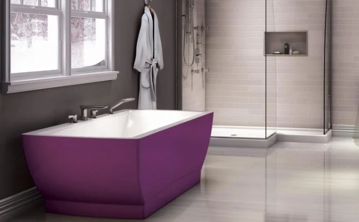contrasting purple bathtub, in a bathroom with medium grey walls, light grey floor, and a shower cabin, with white subway tiles
