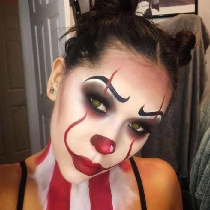 pennywise clown face paint, inspired by the film it, worn by a young woman, with dark hair and green eyes
