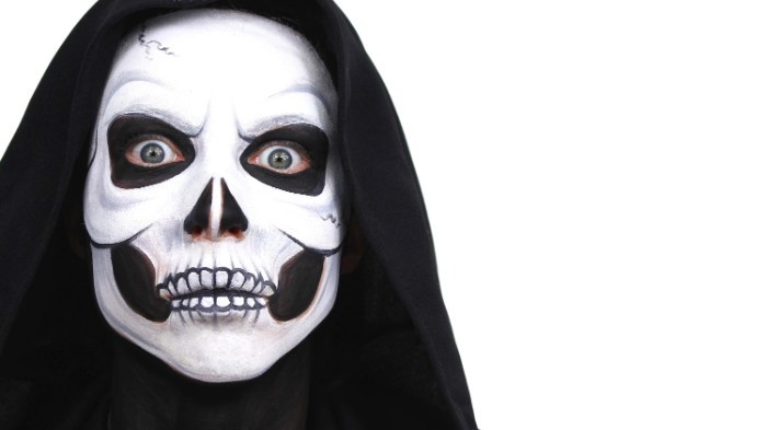 person wearing a black hood, with a realistic skull face paint, done with white and black paint