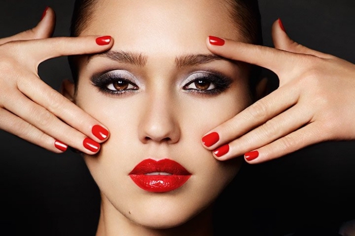 smokey eye make up, with silver and dark grey eye shadow, christmas eye makeup, on jessica alba, wearing red lipstick, and matching red nail polish